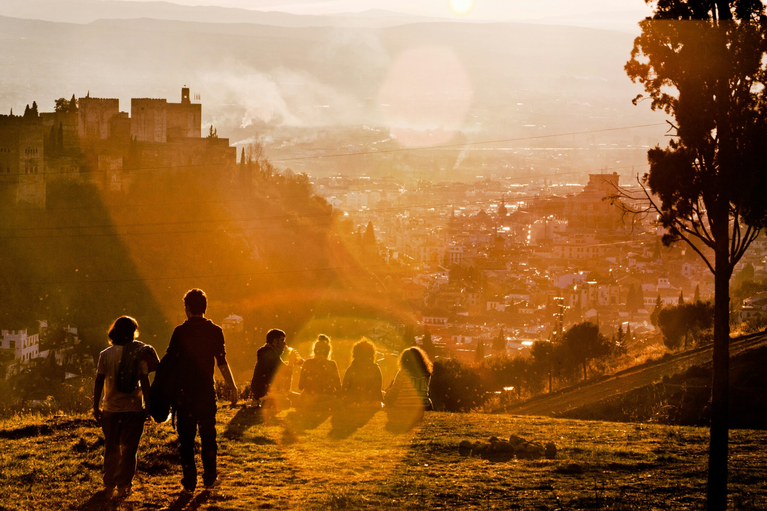 Young people gather to enjoy a beautiful sunset in Granada, Spain